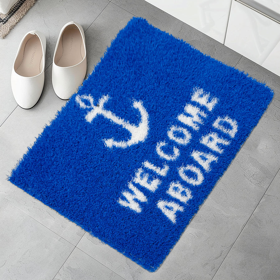 Feblilac Welcome Aboard PVC coil door mat in a bright bathroom beside the bathtub