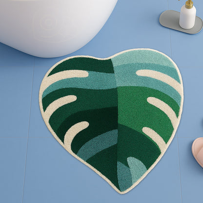 Feblilac Green Leaves with Pink Heart tufted bath mat in a bright bathroom beside the bathtub