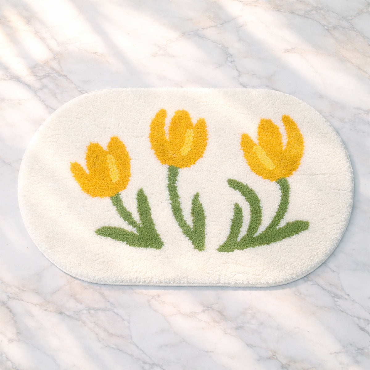 Feblilac Tulip tufted bath mat in a bright bathroom beside the bathtub