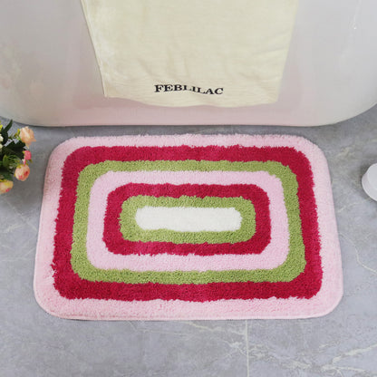 Feblilac Red Green and White Greek Key tufted bath mat in front of a bathroom vanity with fresh towels
