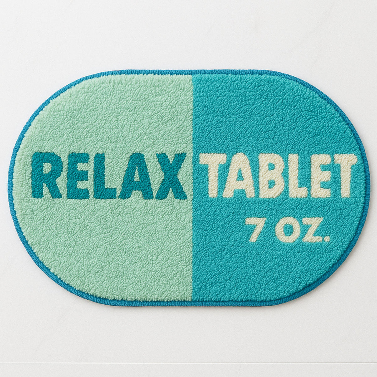 Feblilac Blue Relax tufted bath mat in front of a bathroom vanity with fresh towels