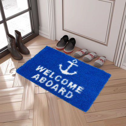 Feblilac Welcome Aboard PVC coil door mat in front of a bathroom vanity with fresh towels