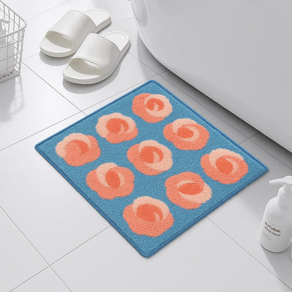 Feblilac Roses on Blue tufted bath mat on a wood floor next to a soaking tub