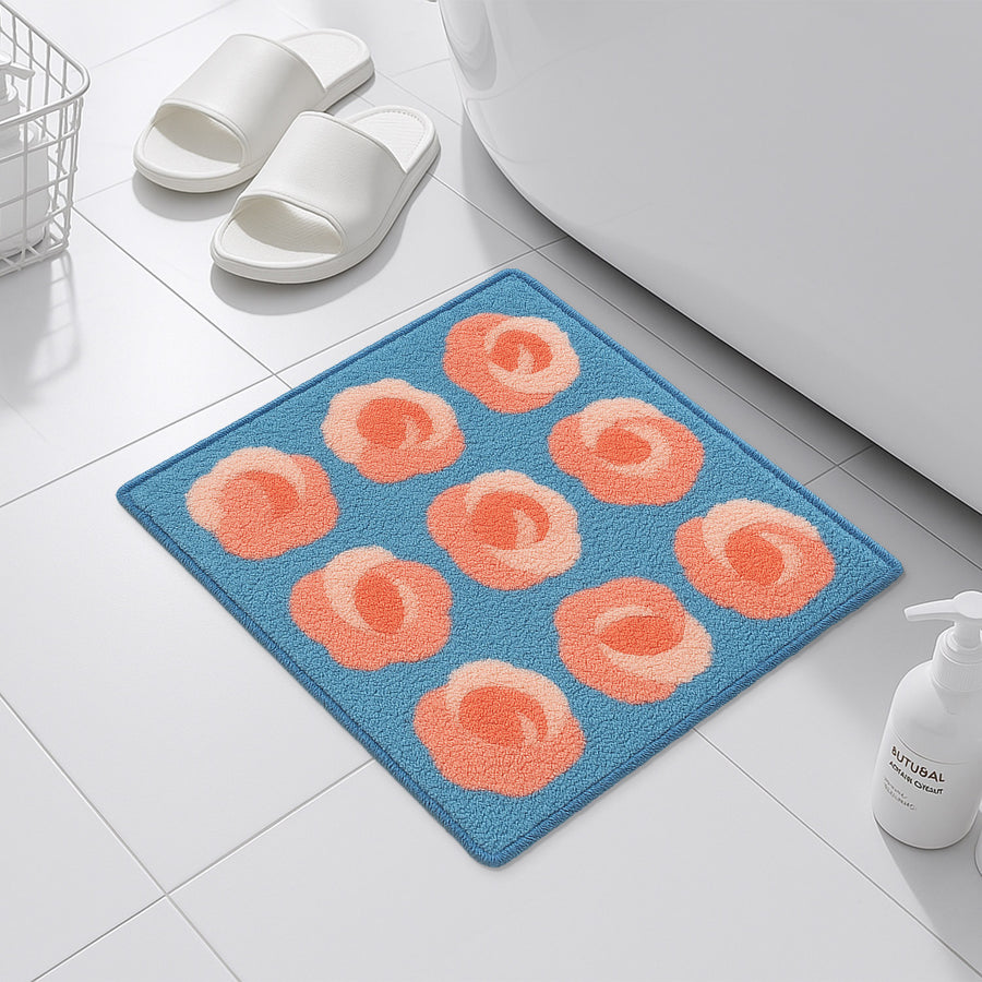 Feblilac Roses on Blue tufted bath mat on a wood floor next to a soaking tub