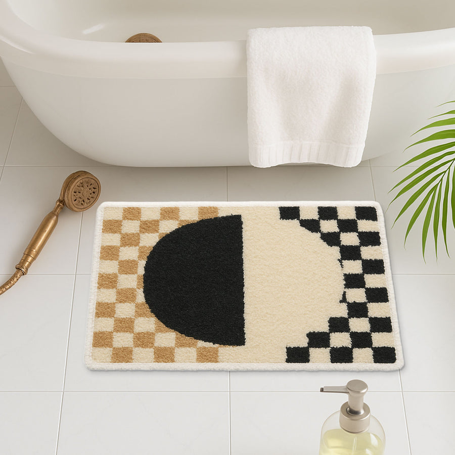 Feblilac Yellow and Black Checkerboard tufted bath mat on a wood floor next to a soaking tub