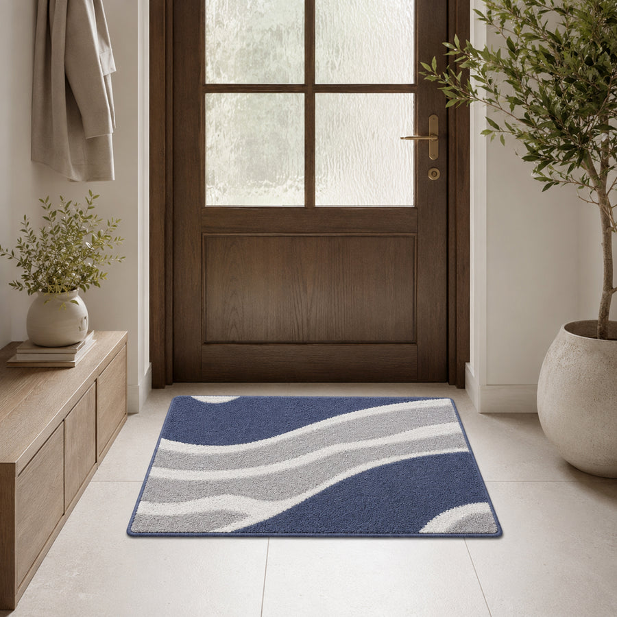 Feblilac White Grey and Blue Minimal Pattern tufted bath mat on a wood floor next to a soaking tub