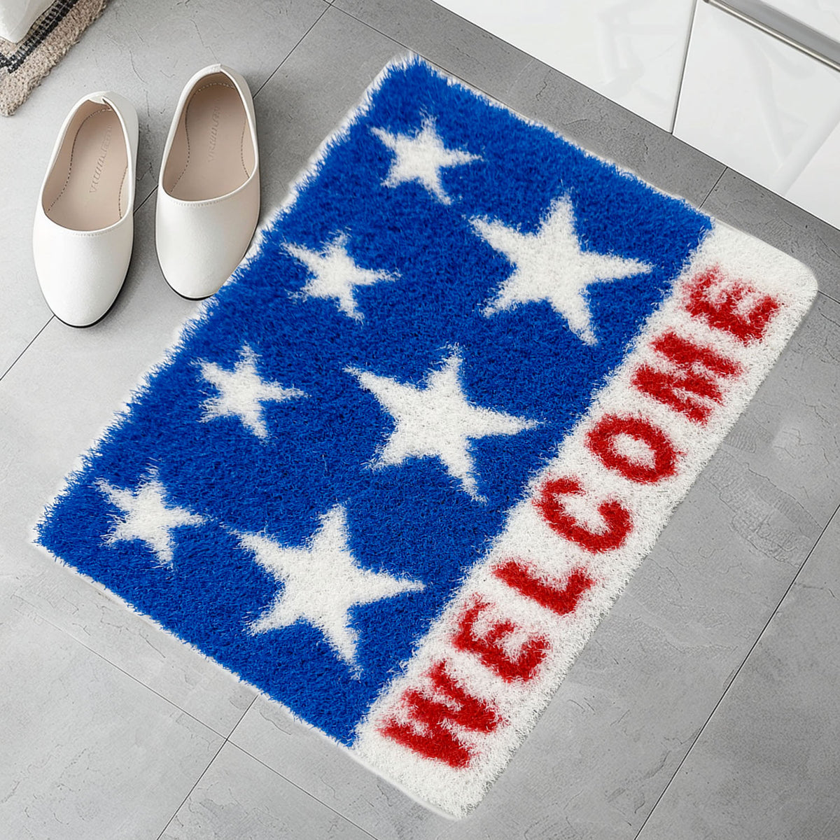 Feblilac Stars and Stripes Welcome PVC coil door mat on a wood floor next to a soaking tub