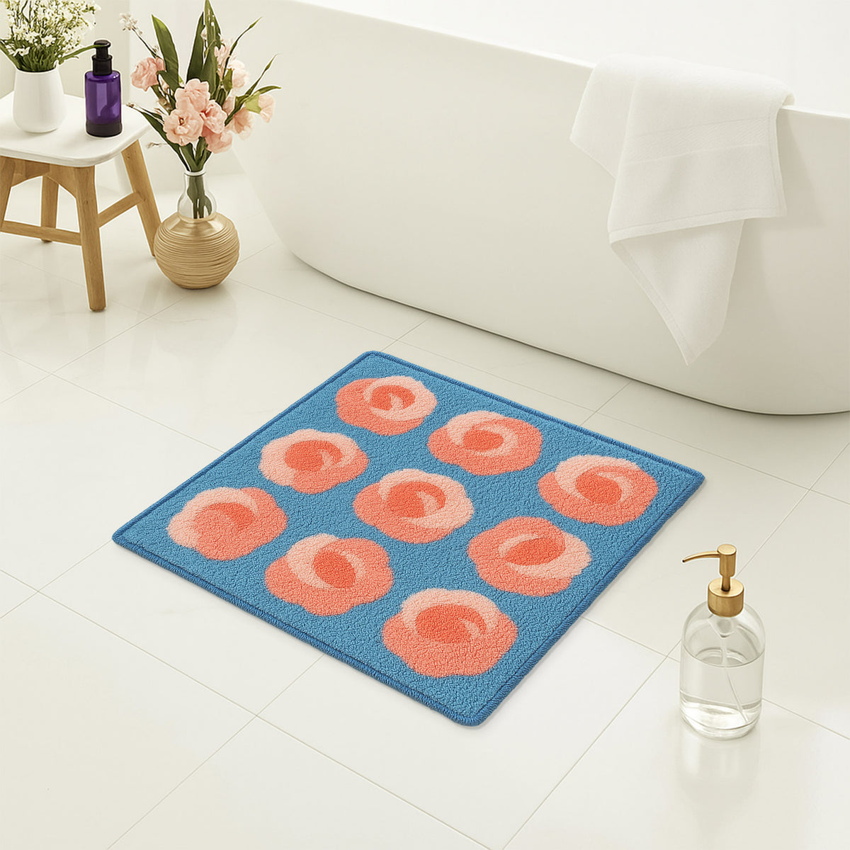 Feblilac Roses on Blue tufted bath mat in a bright bathroom beside the bathtub