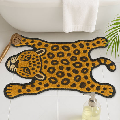 Feblilac Leopard tufted bath mat on a wood floor next to a soaking tub