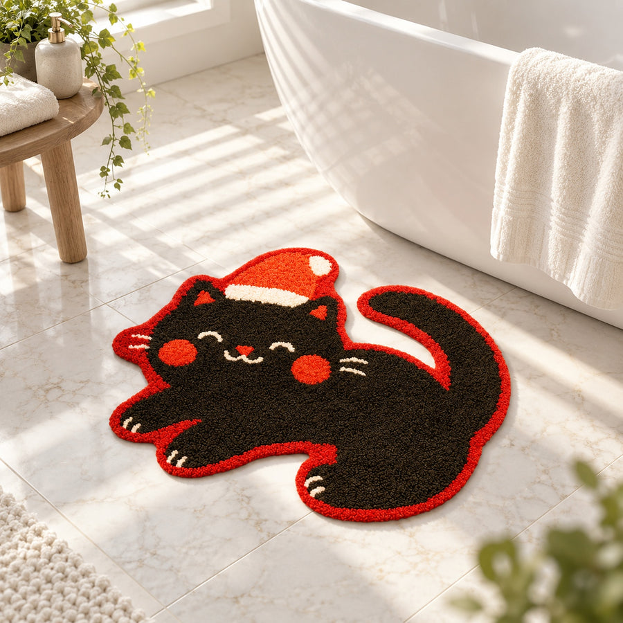 Feblilac Christmas Cat tufted bath mat on a wood floor next to a soaking tub