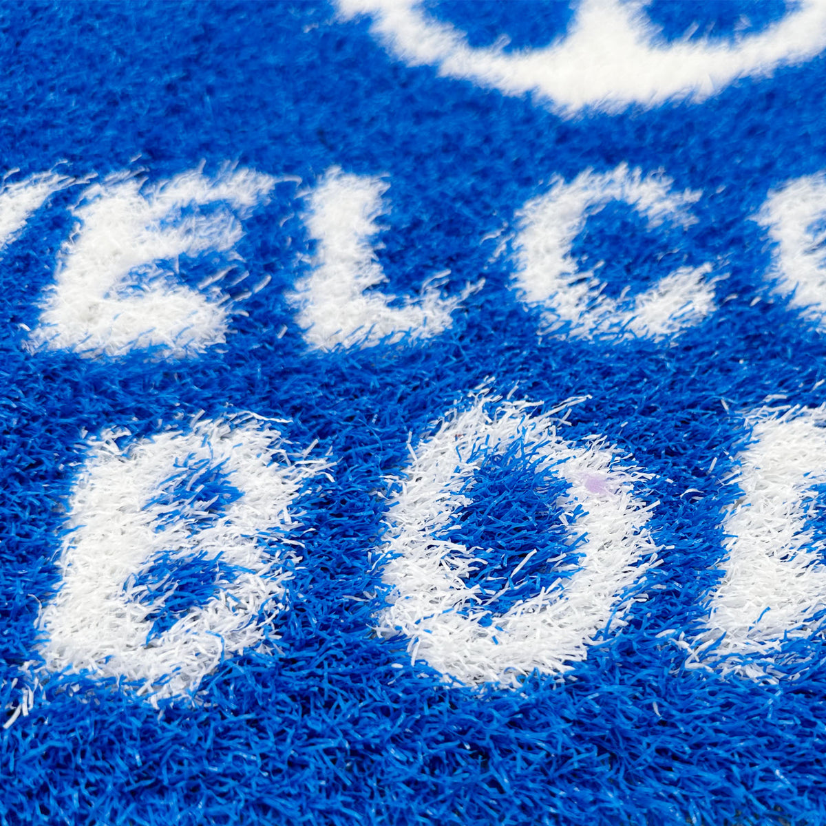 Feblilac Welcome Aboard PVC coil door mat on a wood floor next to a soaking tub
