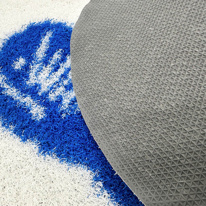 Feblilac Whalecome PVC coil door mat on a wood floor next to a soaking tub