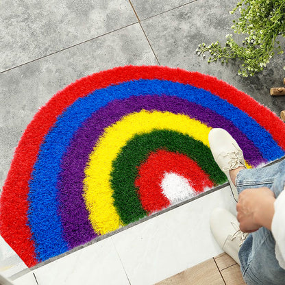 Feblilac Semicircle Rainbow PVC coil door mat on a wood floor next to a soaking tub