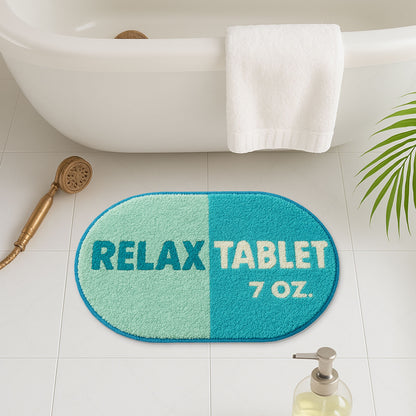 Feblilac Blue Relax tufted bath mat on a wood floor next to a soaking tub