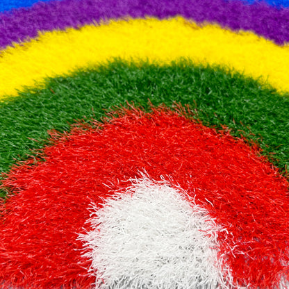 Feblilac Semicircle Rainbow PVC coil door mat in a sunny bathroom with a potted plant