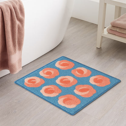 Feblilac Roses on Blue tufted bath mat in front of a bathroom vanity with fresh towels