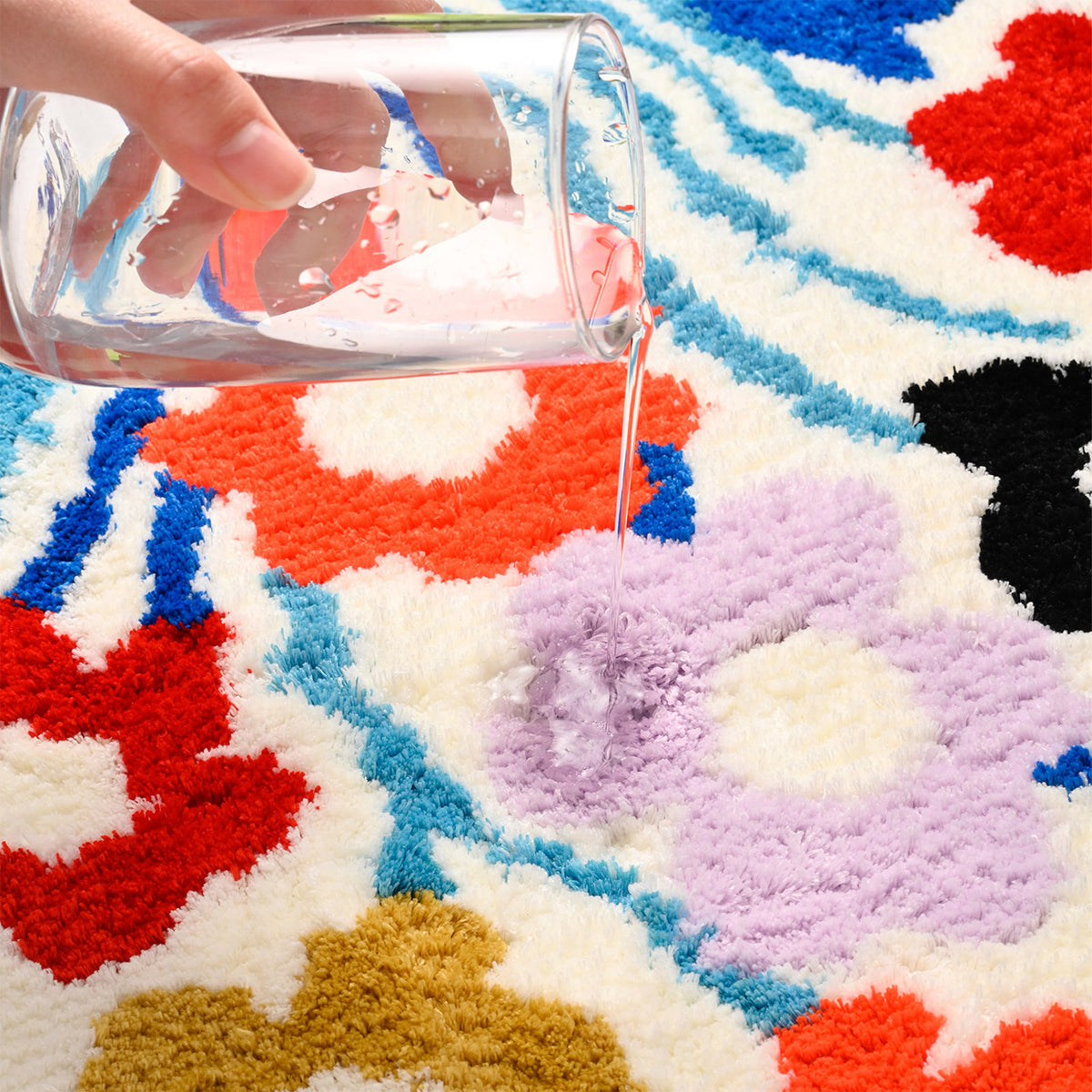 Feblilac Round Flower Garden tufted bath mat by the sink with slippers and a towel basket