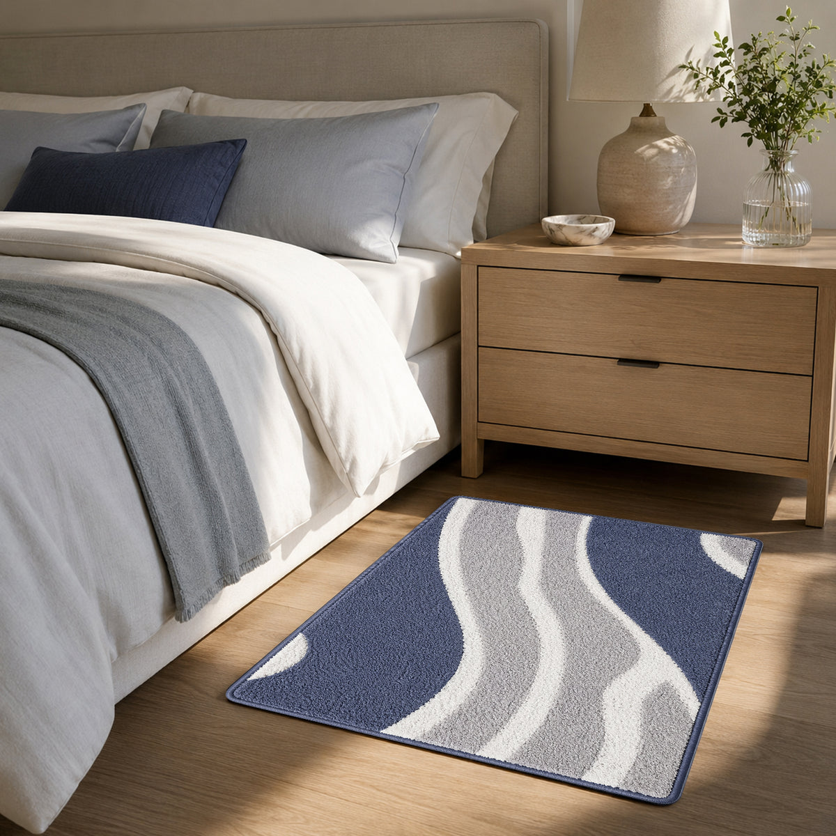 Feblilac White Grey and Blue Minimal Pattern tufted bath mat by the sink with slippers and a towel basket