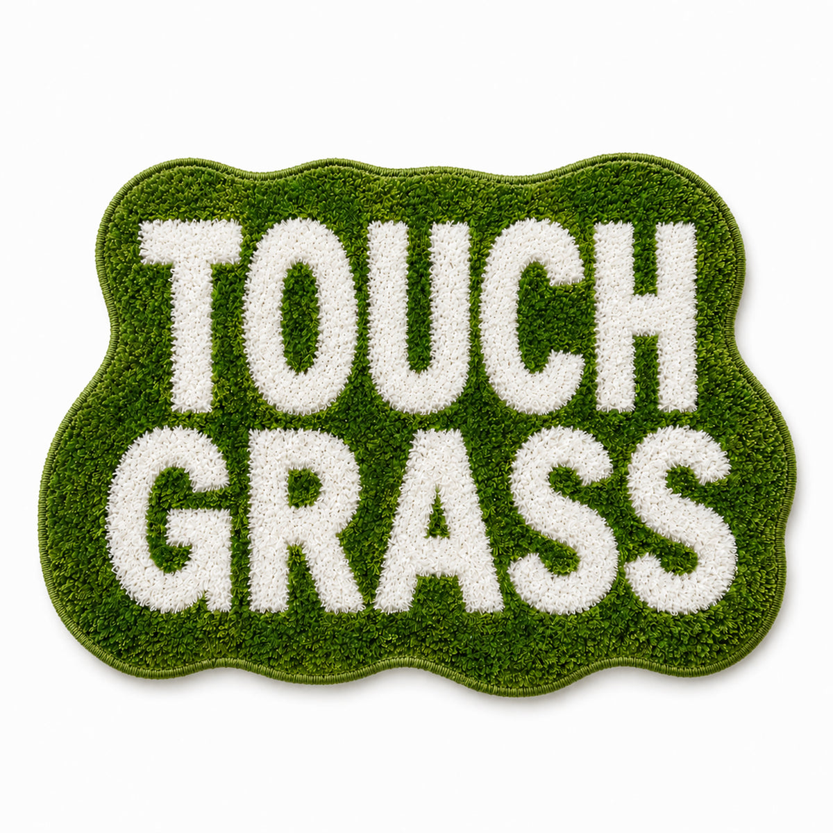 Flat lay of Feblilac TOUCH GRASS tufted bath mat in green scalloped shape