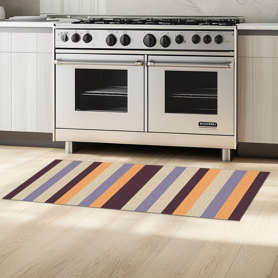 Feblilac Orange and Purple Stripes kitchen mat on a wood floor beside the sink
