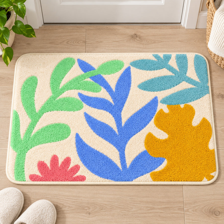 Feblilac Colorful Tropical Leaves tufted bath mat in a bright bathroom beside the bathtub