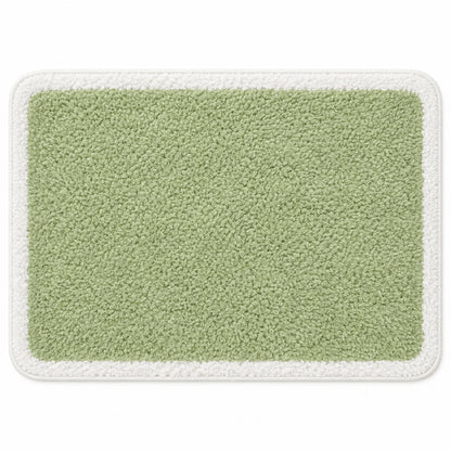 Feblilac Green with White Border tufted bath mat in a bright bathroom beside the bathtub