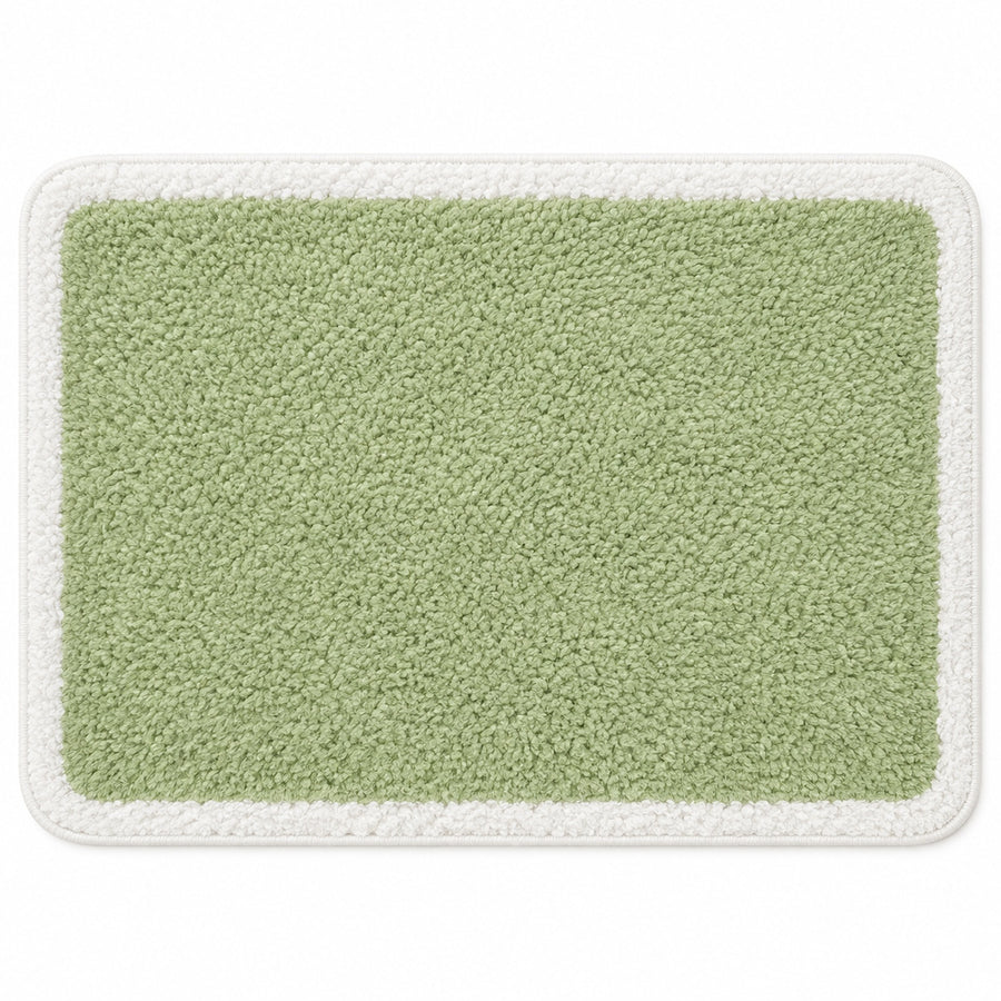 Feblilac Green with White Border tufted bath mat in a bright bathroom beside the bathtub