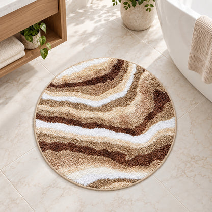 Feblilac Jupiter Marble Round tufted bath mat on a tile floor beside the vanity