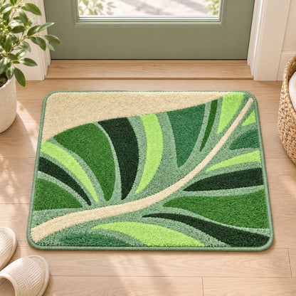 Feblilac Flowing Green Leaves tufted bath mat in front of a bathroom vanity with fresh towels