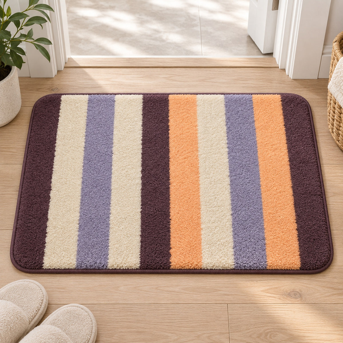 Feblilac Orange and Purple Stripes tufted bath mat in front of a bathroom vanity with fresh towels