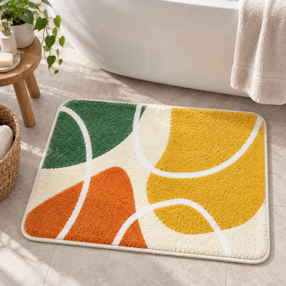 Feblilac Red Yellow Green Abstract Curves tufted bath mat in front of a bathroom vanity with fresh towels