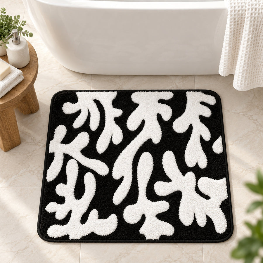 Feblilac Coral tufted bath mat in front of a bathroom vanity with fresh towels