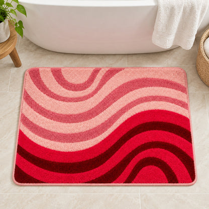 Feblilac Minimal Abstract Curves tufted bath mat in front of a bathroom vanity with fresh towels