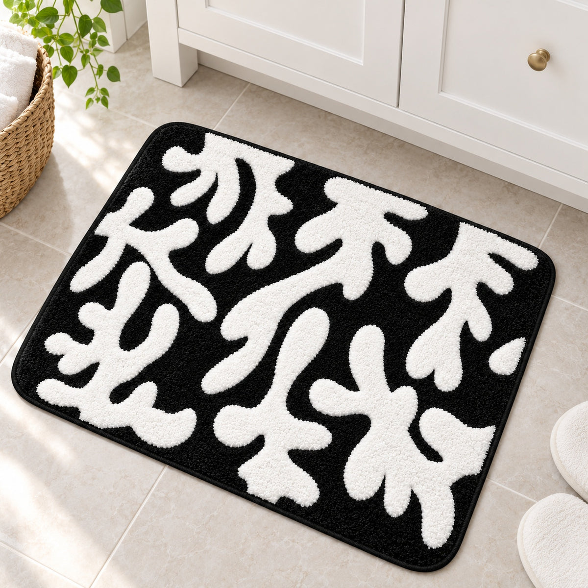 Feblilac Coral tufted bath mat on a wood floor next to a soaking tub