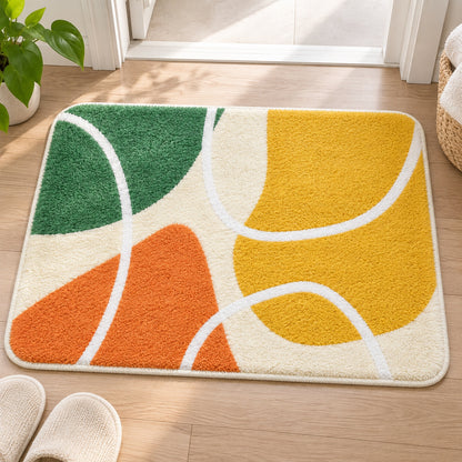 Feblilac Red Yellow Green Abstract Curves tufted bath mat on a wood floor next to a soaking tub