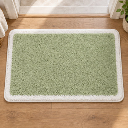 Feblilac Green with White Border tufted bath mat in a sunny bathroom with a potted plant