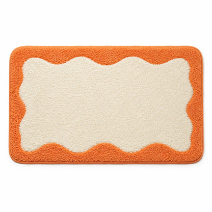 Feblilac Orange Wavy Border tufted bath mat in a bright bathroom with a potted plant