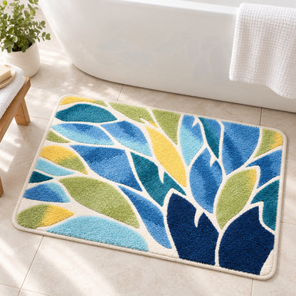 Feblilac Blue and Green Leaves Tufted Bath Mat – Botanical Bathroom Rug beside a bathtub with white towels