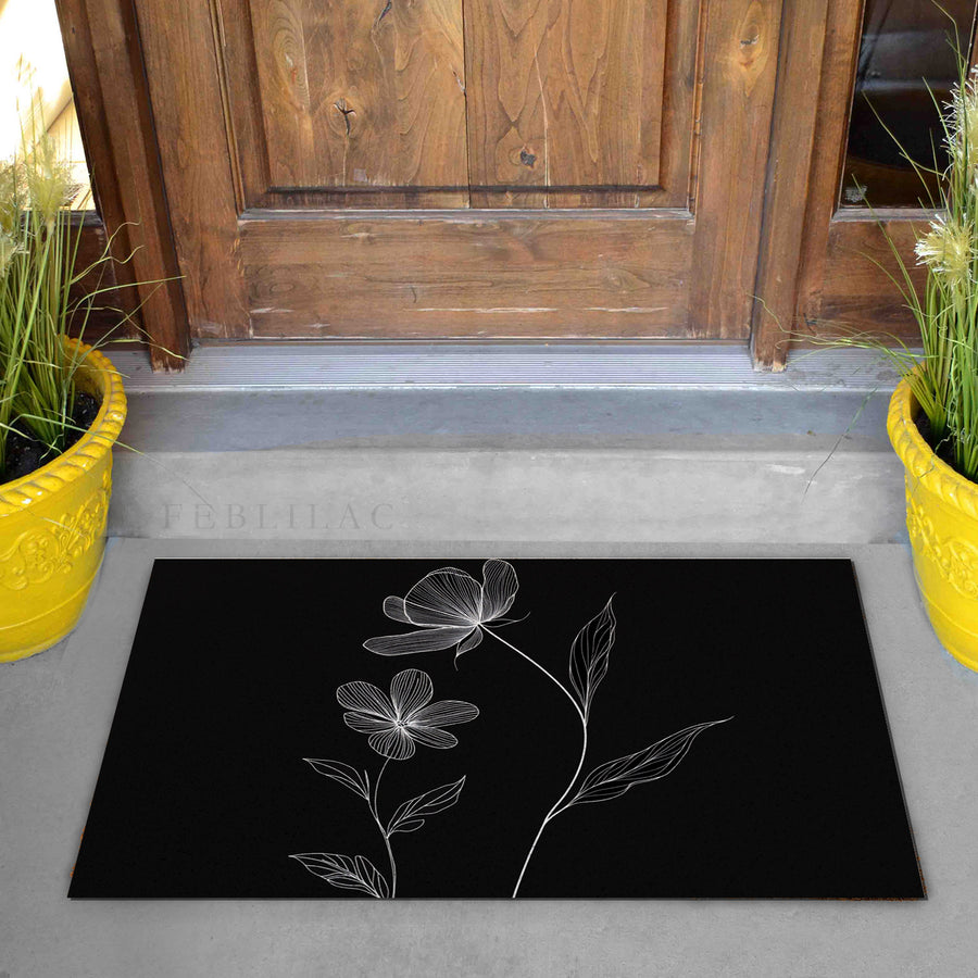 Feblilac Minimal Black and White Flowers PVC coil door mat on a doorstep with potted plants