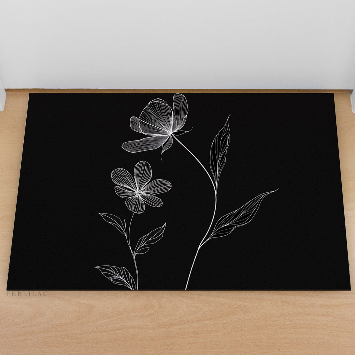 Feblilac Minimal Black and White Flowers PVC coil door mat at an entryway with a wooden door