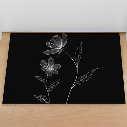 Feblilac Minimal Black and White Flowers PVC coil door mat at an entryway with a wooden door
