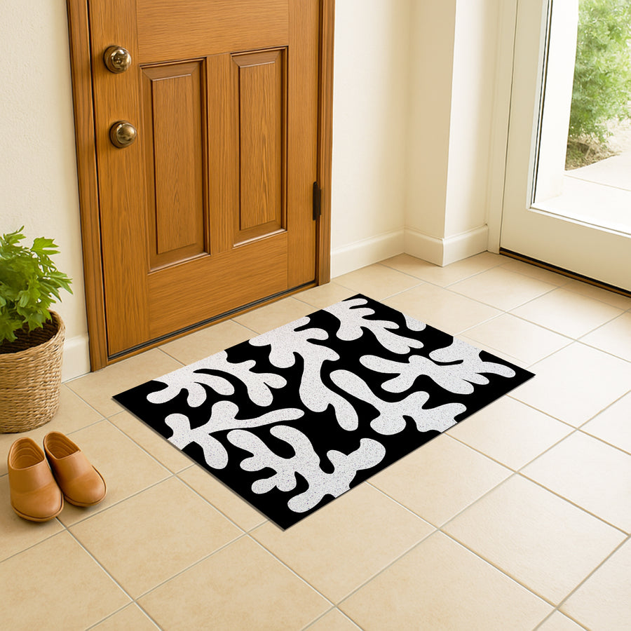 Feblilac Coral PVC coil door mat at an entryway with a wooden door
