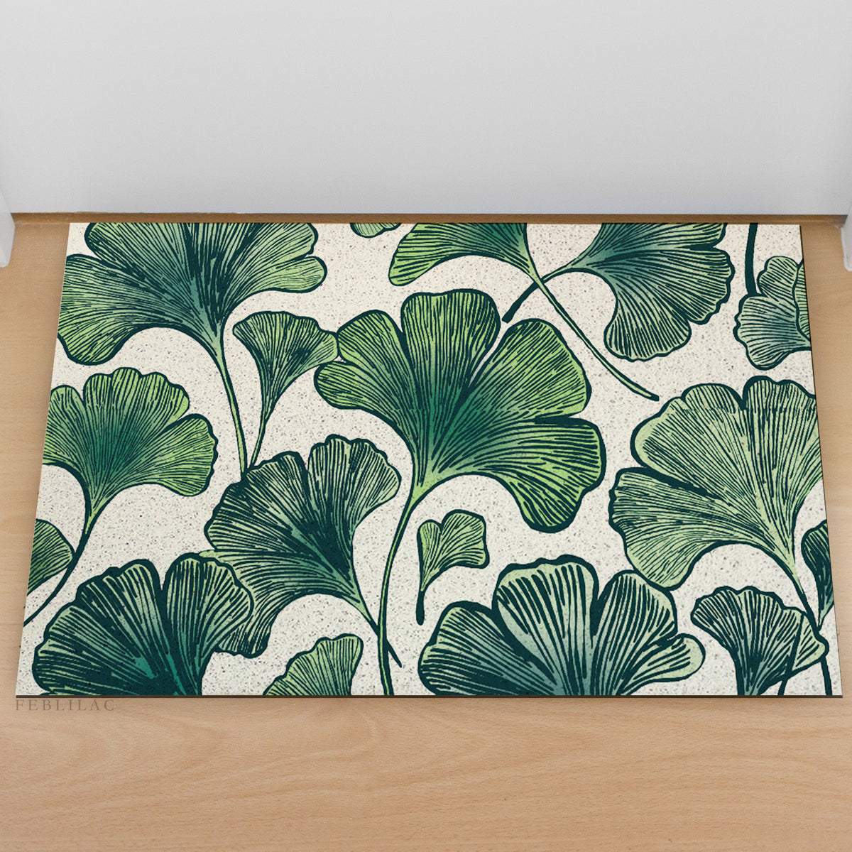 Feblilac Ginkgo Leaf Pattern PVC coil door mat at an entryway with a wooden door