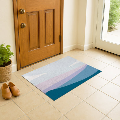 Feblilac Blue and Purple Mountain Mist PVC Coil Door Mat – Abstract Landscape Entrance Mat on a tiled porch by a wooden door