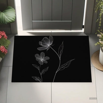 Feblilac Minimal Black and White Flowers PVC coil door mat beside a doorway on grey stone