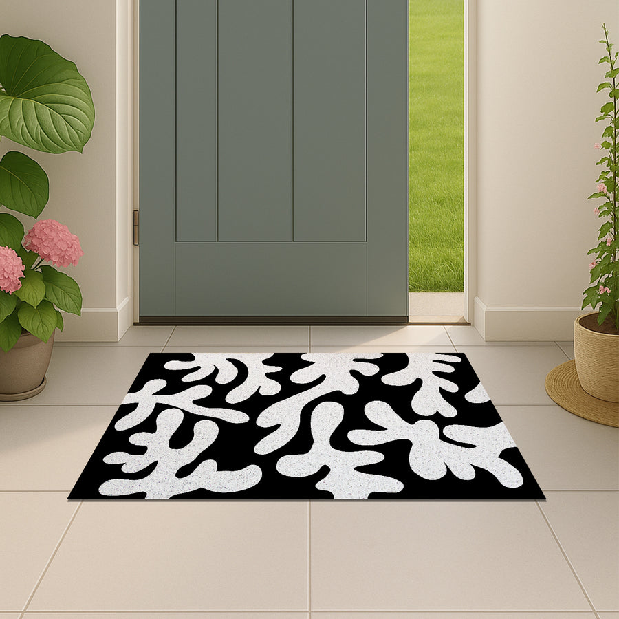 Feblilac Coral PVC coil door mat beside a doorway on grey stone