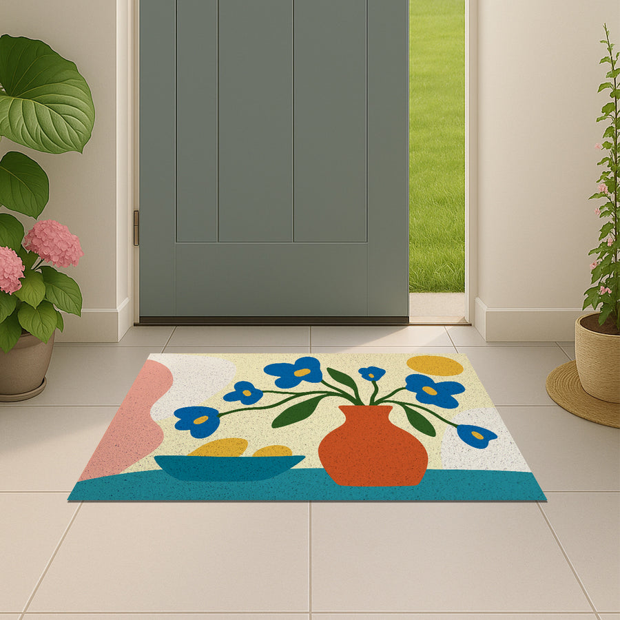 Feblilac Vase and Blue Flowers PVC coil door mat beside a doorway on grey stone