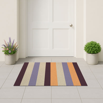 Feblilac Orange and Purple Stripes PVC coil door mat on a paved patio by the entrance