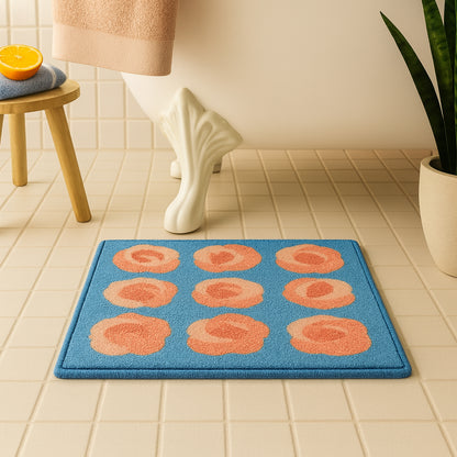 Feblilac Roses on Blue tufted bath mat in a minimal bathroom with marble tile
