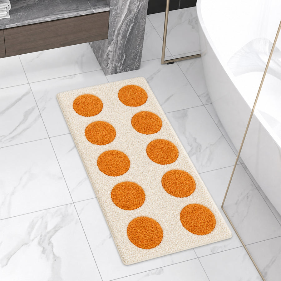 Orange and cream moon phase bath runner in front of tub